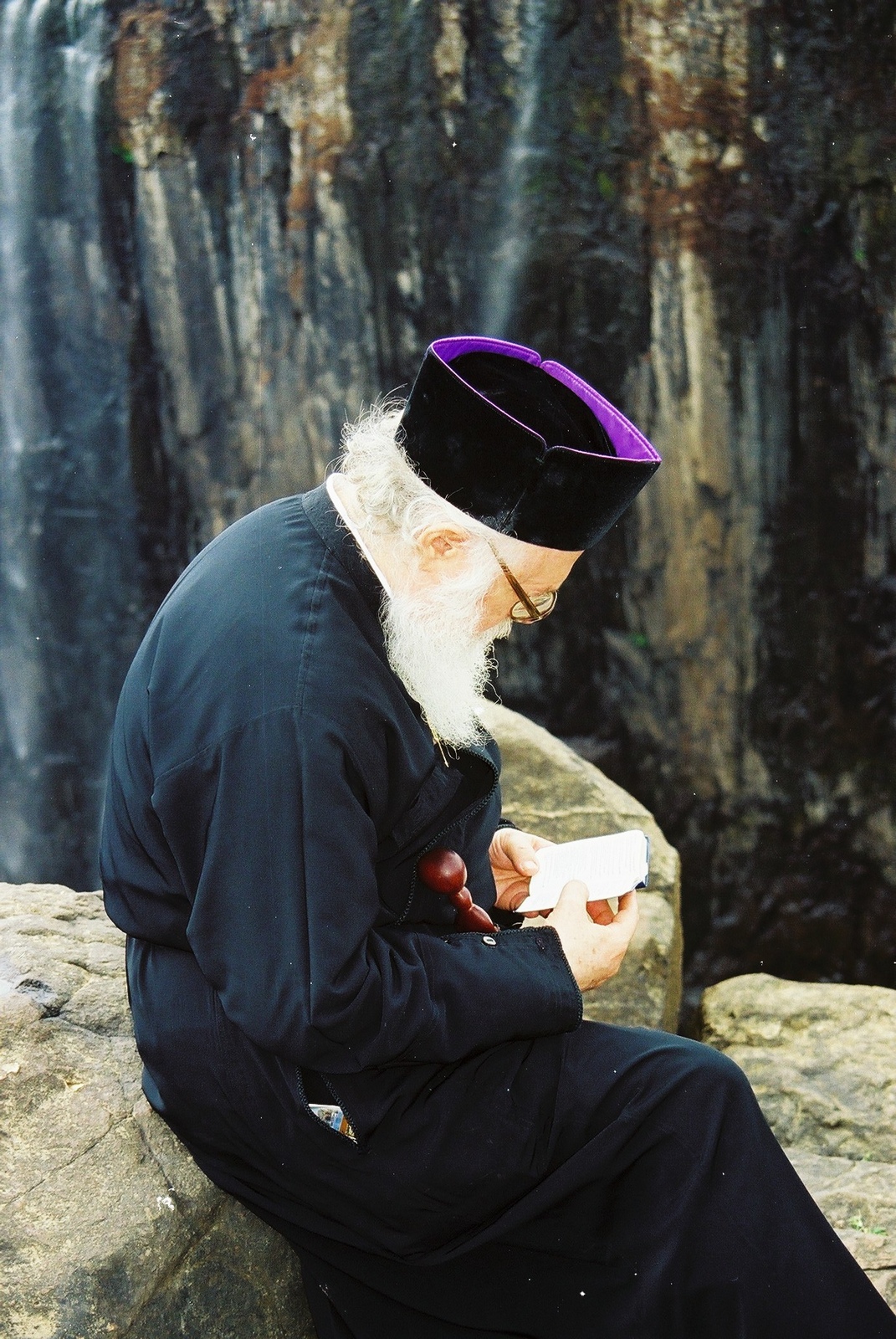 Archbishop Anastasios Yannulatos reading the Bible at Victoria falls, 1998