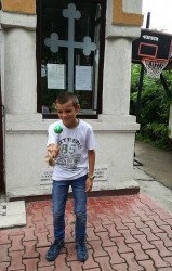 Florina 
Marian, one of the priest&#039s sons, playing kendama after the Divine Liturgy at the Nefliu Parish. 
2017-07-16 16:33:49