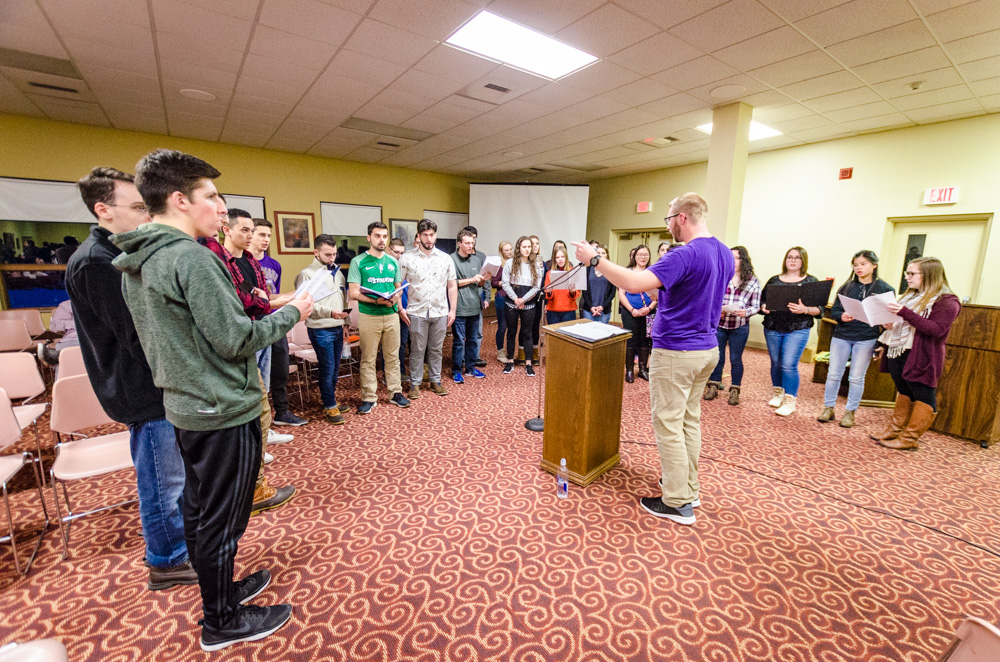 Students sing the responses during Vespers 