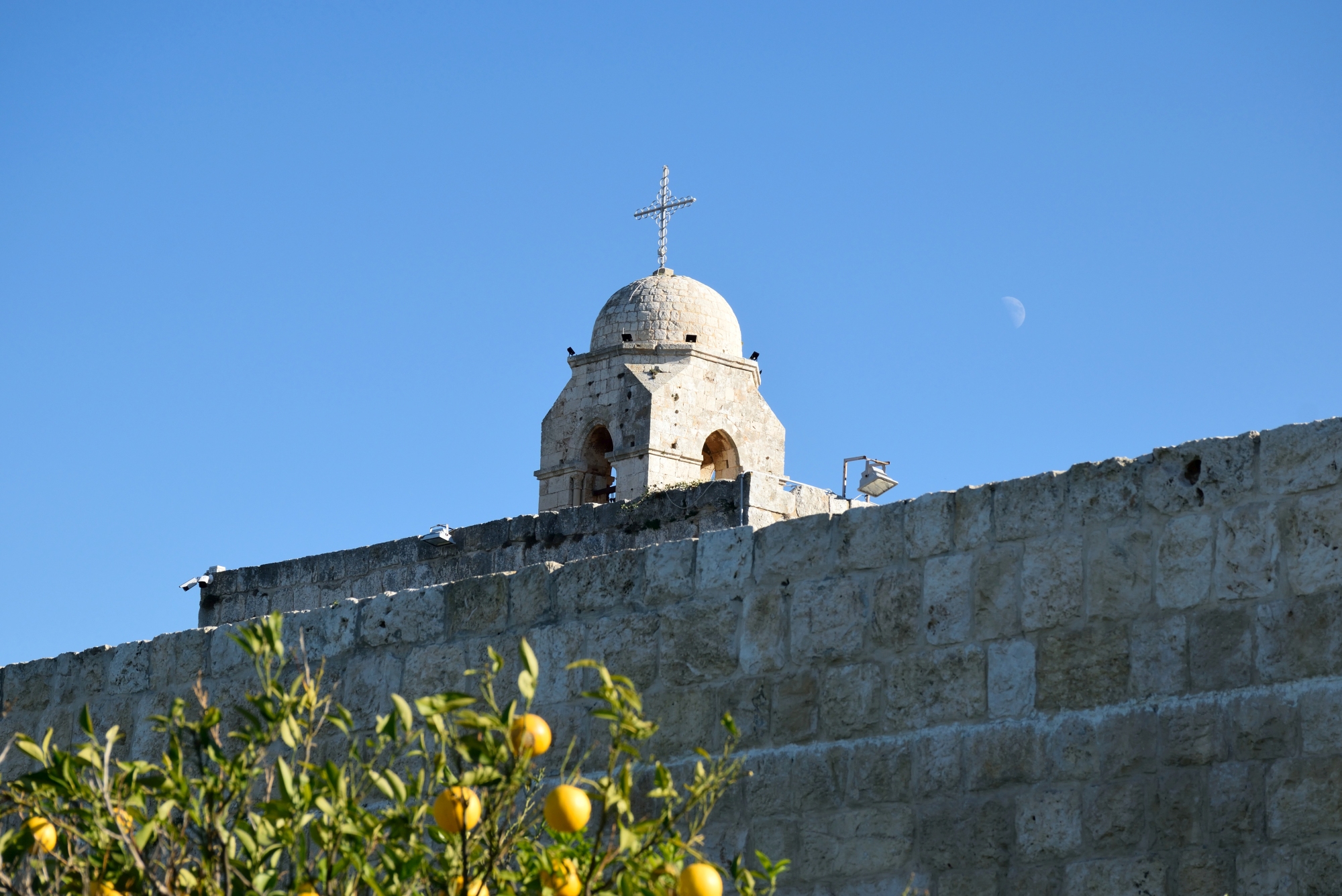 Dome of the Balamand monastery and the moon during the day