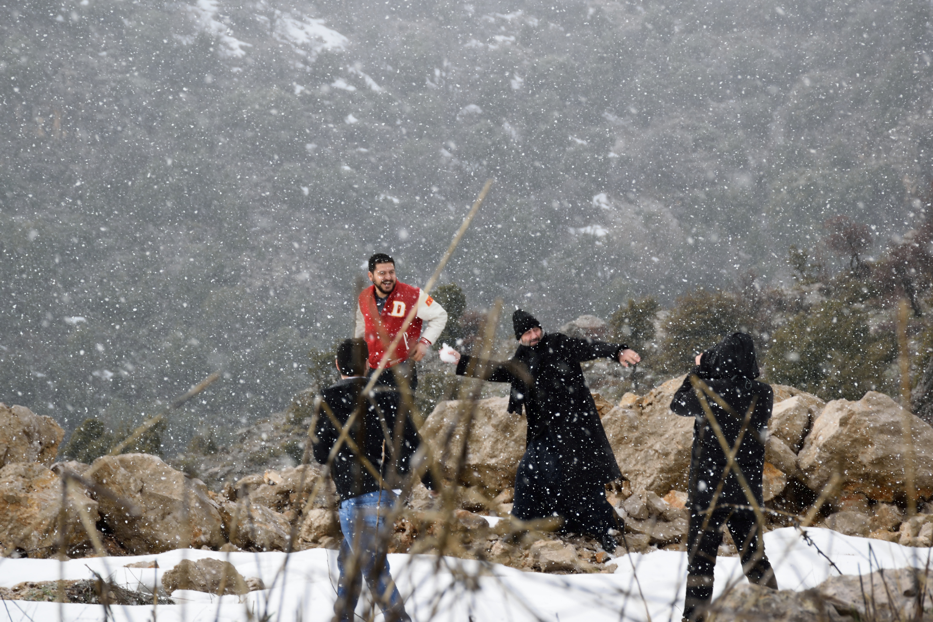 Archimandrite Maxim and seminarians playing in snow