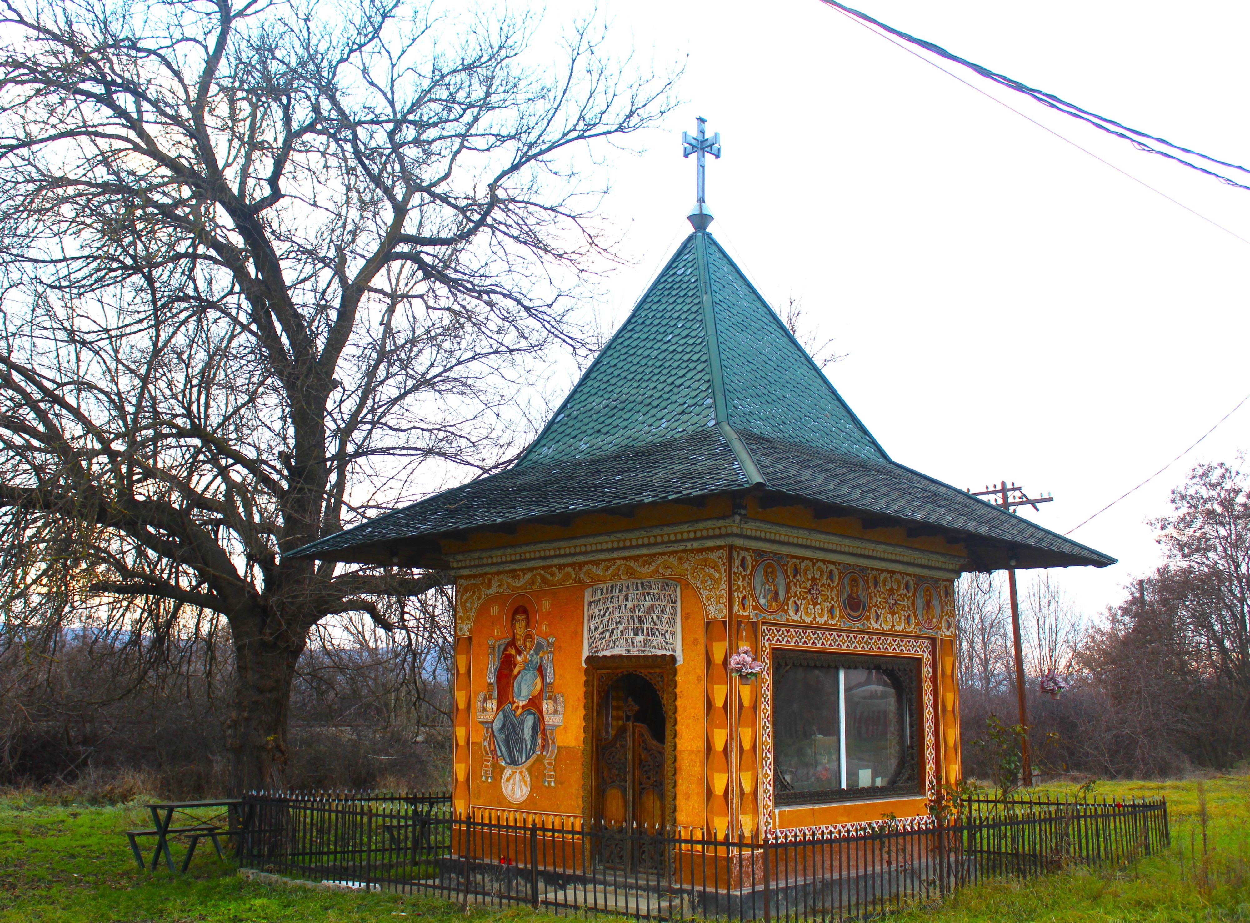A small church on the side of the road protects the drivers