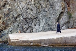 felix 
 A monk strolling on the dock of the Athos monastery of Agiou Grigoriou 