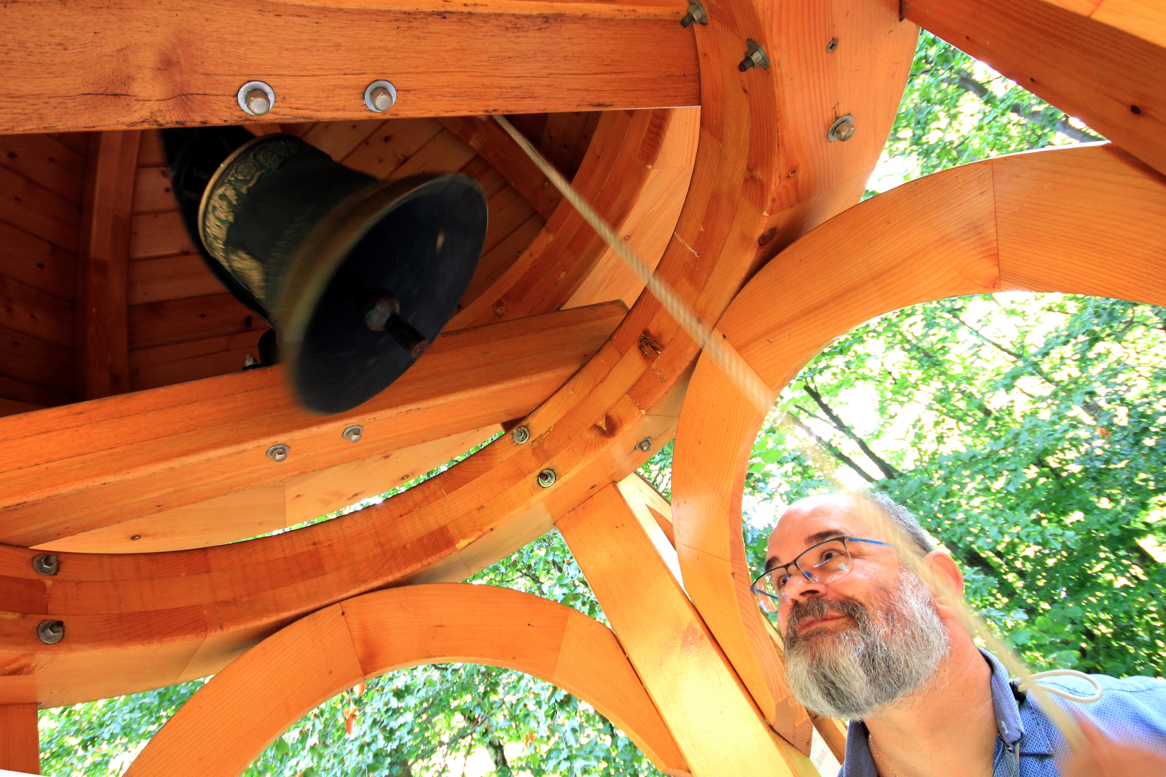 Fr. Igor ringing a bell in "three chapels" site close to Runina village