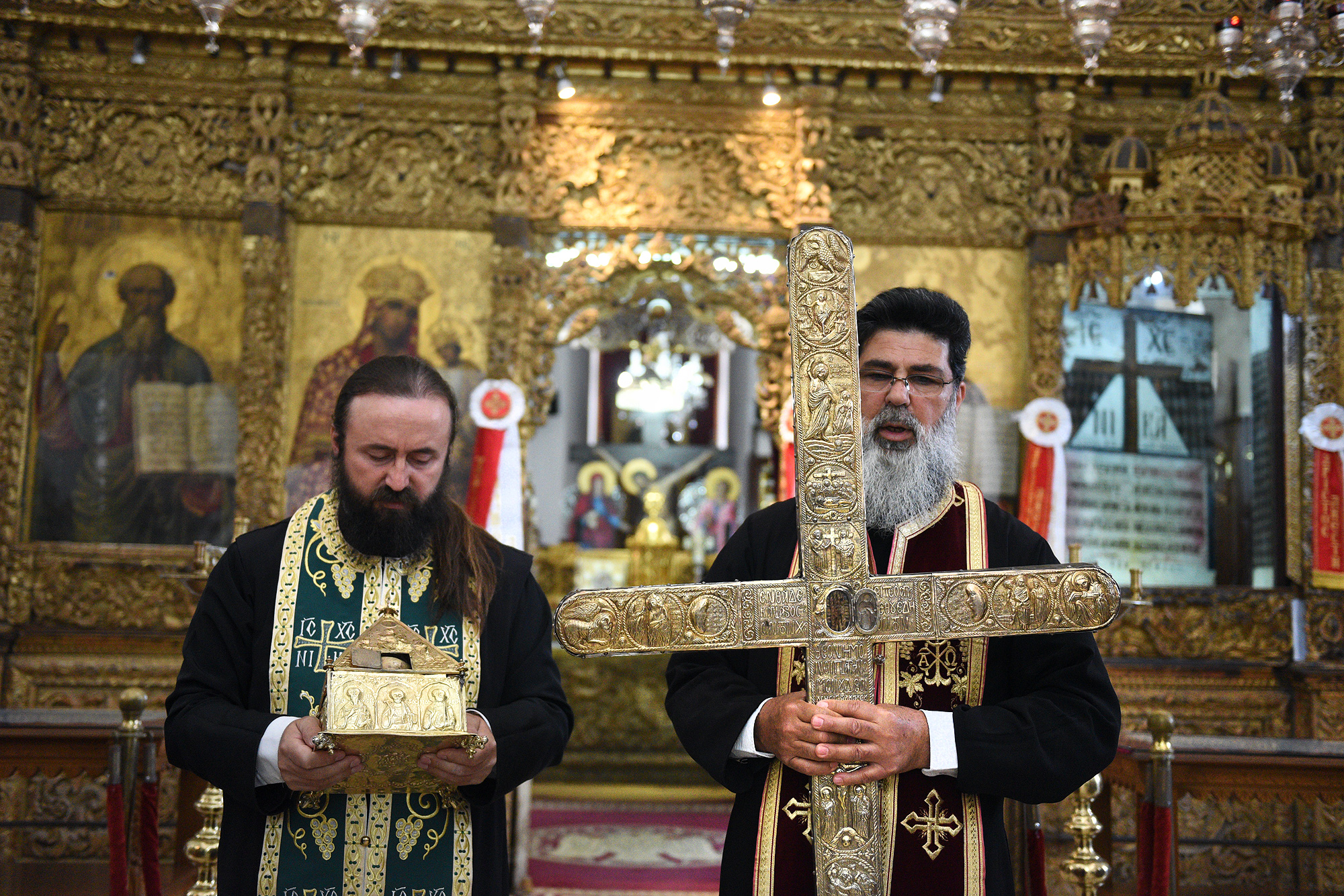 Fr Neophytos from Omodos holding piece of Holy Cross and rope  