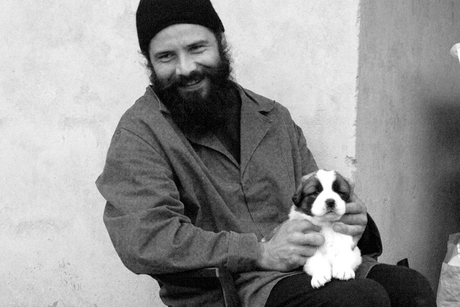 The young monk and the young caucasian dog 